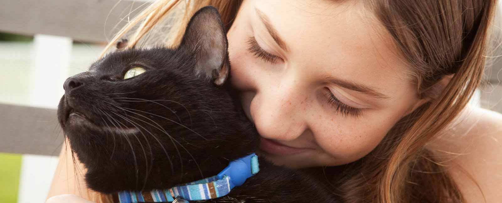 girl holding cat